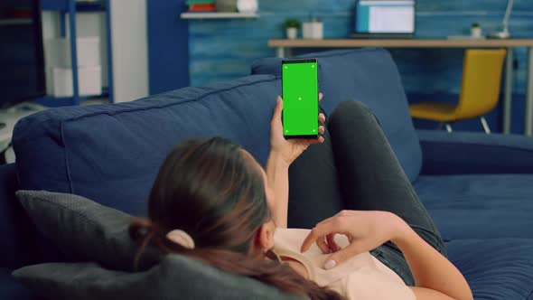 Casual Woman Holding Smartphone with Mock Up Green Screen alt