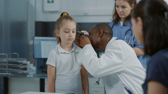 Doctor doing otology examination with otoscope to see ear infection