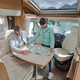 Couples in RV Camper looking at the local map for the trip. - PhotoDune Item for Sale