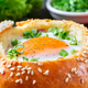 Eggs baked in a bun with ham, cheese and green onion, close-up. Banner, black background - PhotoDune Item for Sale