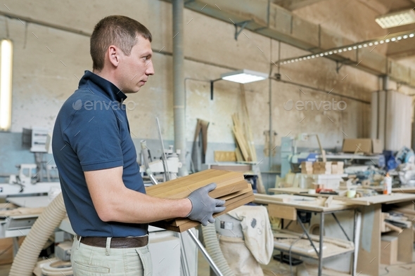 Male carpenter making wooden designer furniture for an individual private order