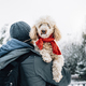 Happy pet and his owner having fun in the snow in winter holiday season. - PhotoDune Item for Sale
