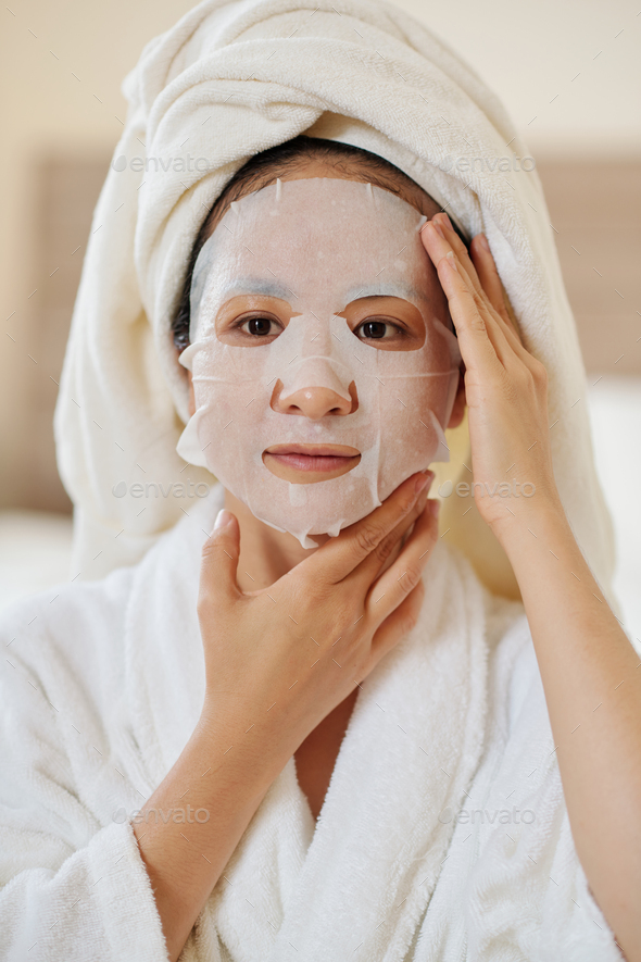 Woman Applying Rejuvenating Mask
