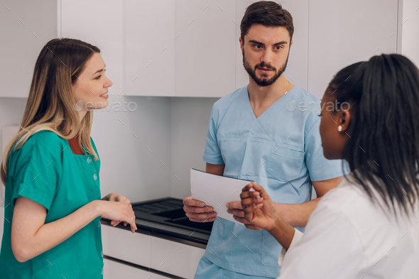 Multiracial team of doctors discussing a patients condition while working in a hospital