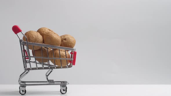 Walnuts are Poured Into the Grocery Cart When Filling It