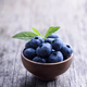 Bowl of fresh blueberries on rustic wooden table. - PhotoDune Item for Sale