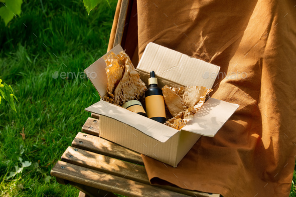 Cosmetic in carton box on brown cloth and wooden chair
