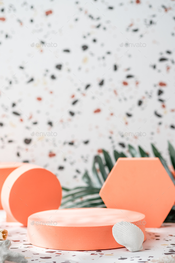 peach geometric pedestal on terrazzo background with summer sunlight and green palm leaf
