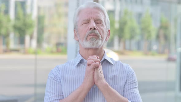 Old Man Praying to God with Folded Hands Outdoor alt