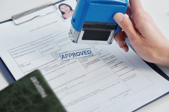 Putting Stamp On Application Form - Stock Photo - Images