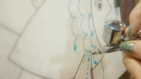 Woman Artist Learns to Paint with Airbrush with Acrylic Dye Paper and Easel alt