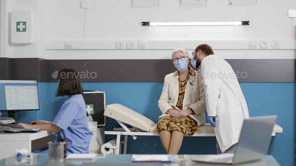 Otologist consulting senior woman using medical otoscope