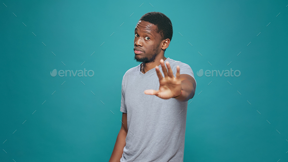 Portrait of person doing talk to the hand rejection gesture