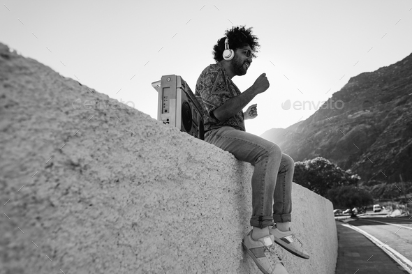 African americam man listening music outdoor - Focus on face - Black and white editing