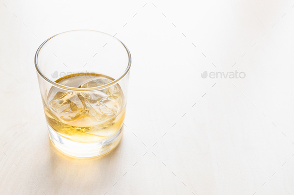 portion whiskey on the rocks in glass on table - Stock Photo - Images