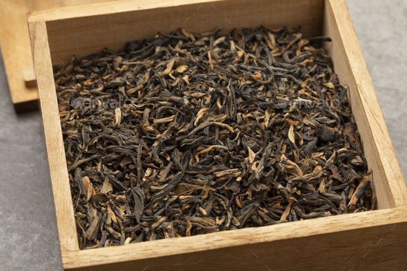 Wooden box with Chinese Yunnan Mao Feng tea close up - Stock Photo - Images