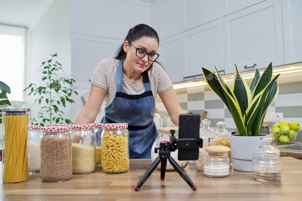 Online broadcast, blog about food, woman in an apron with jars of cereals