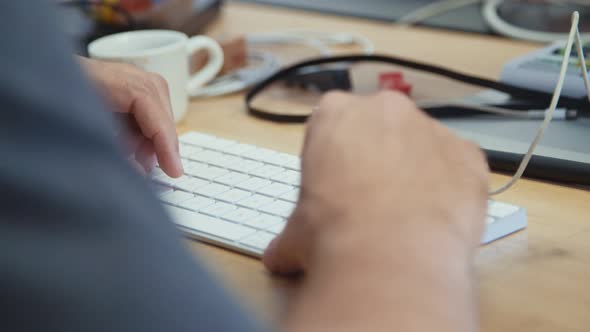 Man hands typing on a laptop computer keyboard alt