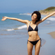 Positive African American female opening her arms on the beach to enjoy her holiday in the sun. - PhotoDune Item for Sale