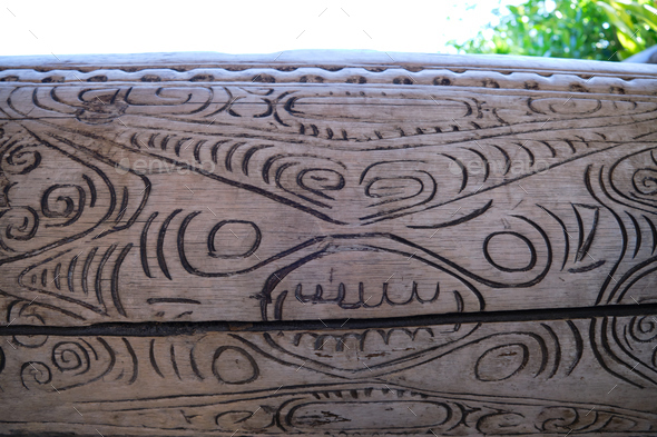 A wooden trunk with artistic engravings of Polynesian motifs