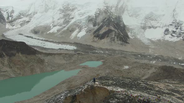Man on Top of Kalapatthar Mountain. Everest and Nuptse. Nepal. Aerial View alt