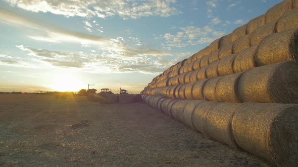 Stack of round hay bales seen in the evening alt