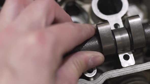 The Mechanic Man Repairs Broken Engine Head Replaces the Camshaft alt