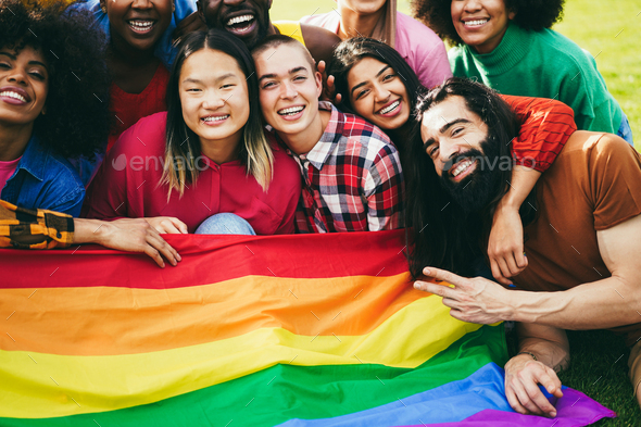 Diverse people having fun holding LGBT rainbow flag outdoor Stock Photo ...