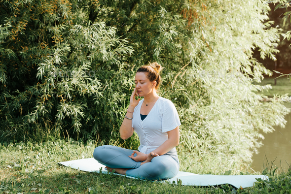Breathing exercise, yoga and meditation practice. Caucasian young woman breathing with one nostril