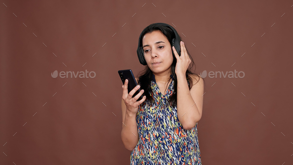 Young adult listening to radio music on wireless headset