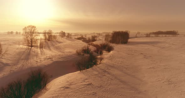 Aerial View of Cold Winter Landscape Arctic Field Trees Covered with Frost Snow Ice River and Sun alt
