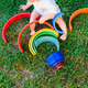 Baby playing with a colorful wooden rainbow on the grass - PhotoDune Item for Sale