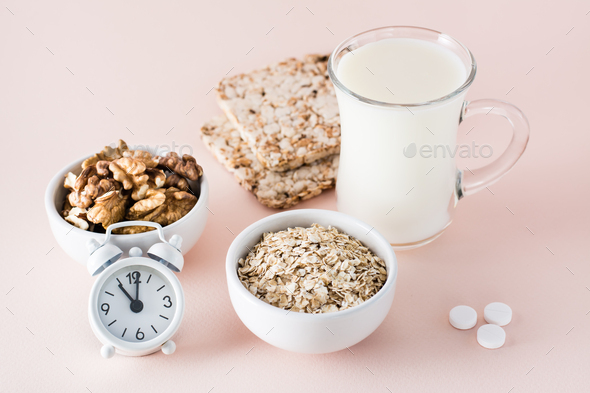 Good sleep. Foods for good sleep - milk, walnuts, crispbread, oatmeal, sleping pill and alarm clock