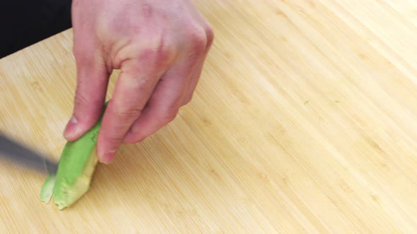 Sushi chef slicing avocado alt