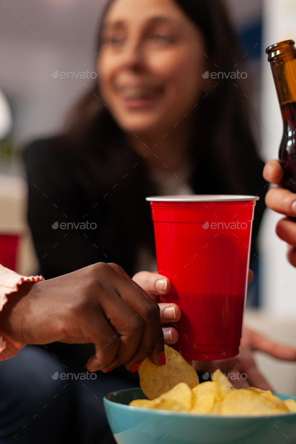 Cheerful people enjoying office party celebration with drinks and ...