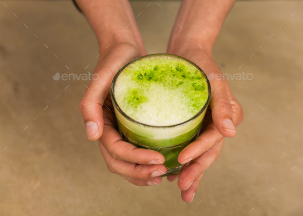 Female hands holding a detox juice - Stock Photo - Images