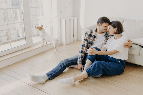Happy newlywed couple move in new apartment, rejoice having spare time together.