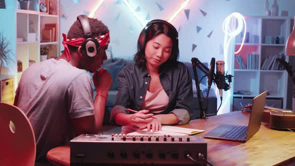 Diverse Male and Female Songwriters Working Together in Home Recording Studio alt