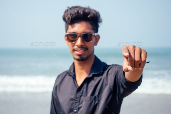 Asian Indian man finger pointing at you focus