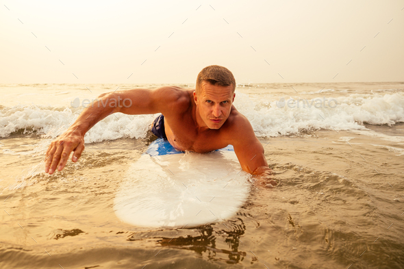 surfing freelancing man muscle and press sport training on the beach