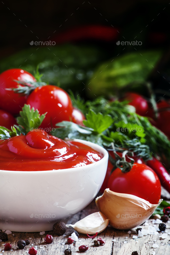Tomato ketchup sauce with garlic, spices and herbs with cherry tomatoes Stock Photo by Olga_Kochina