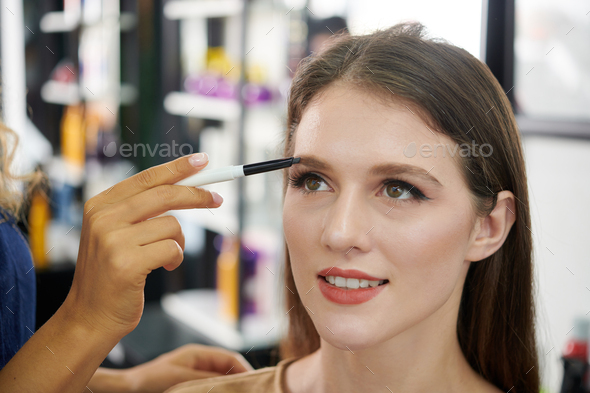 Make-up Artist Filling Brows of Client