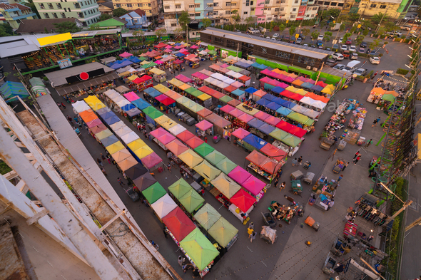 Aerial top view of Night Market people walking street, Colorful tents. Retail shops