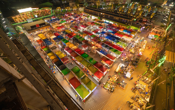 Aerial top view of Night Market people walking street, Colorful tents. Retail shops