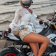 Tanned woman posing with motorcycle in day on beach - PhotoDune Item for Sale