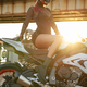 Redhead woman biker riding modern custom bike outdoors - PhotoDune Item for Sale