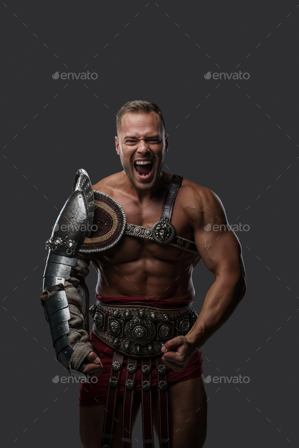 Violent gladiator with naked torso screaming at camera Stock Photo