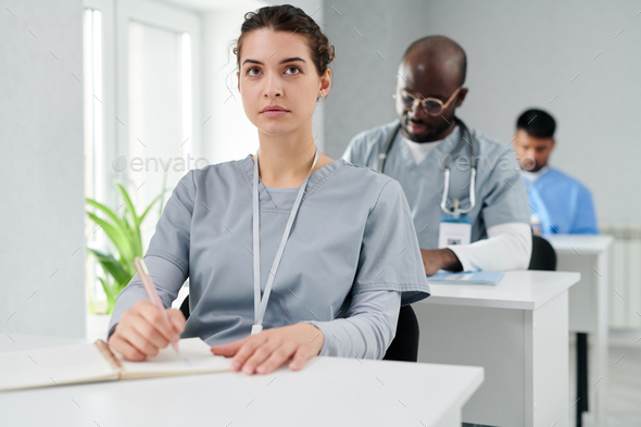 Female intern sitting at lecture at class
