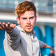 Young concentrated red-haired man practicing exercise  - PhotoDune Item for Sale