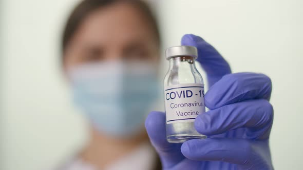 Closeup a Vial with the COVID19 Coronavirus Vaccine in the Hand of a Doctor alt